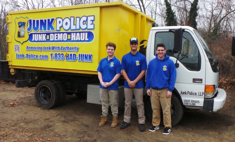 Junk Police crew posing in front of their truck