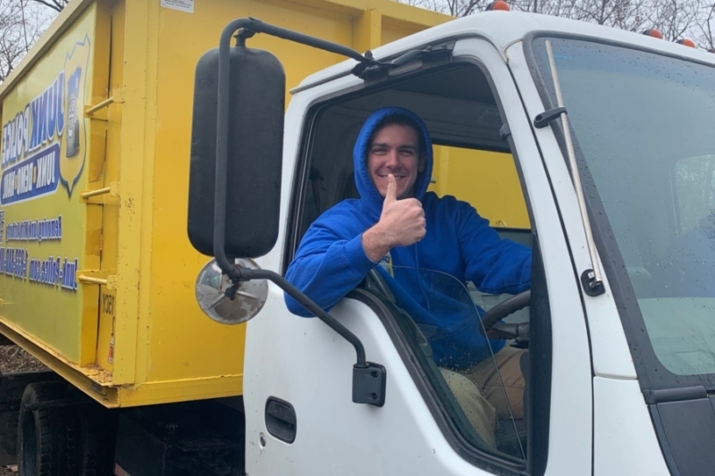 Junk Police professional smiling in the truck ready to provide junk removal services in Springfield, NJ