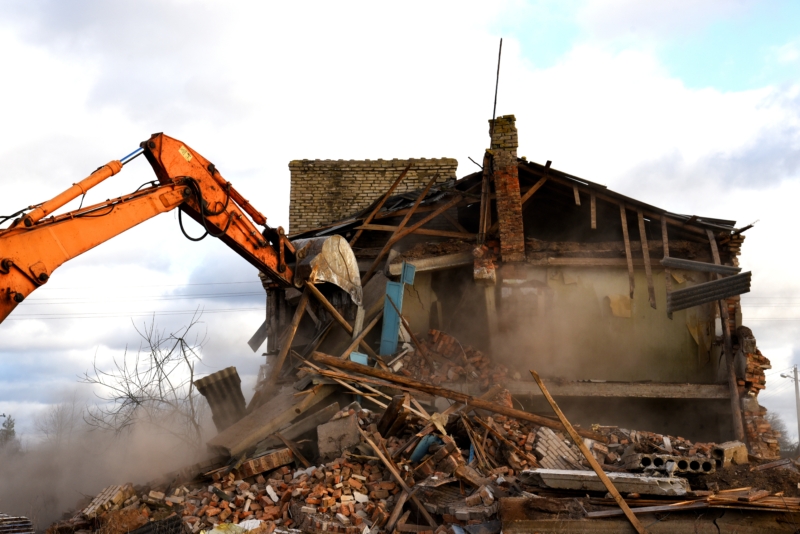 Demolition experts using an excavator for home demolition in New Jersey